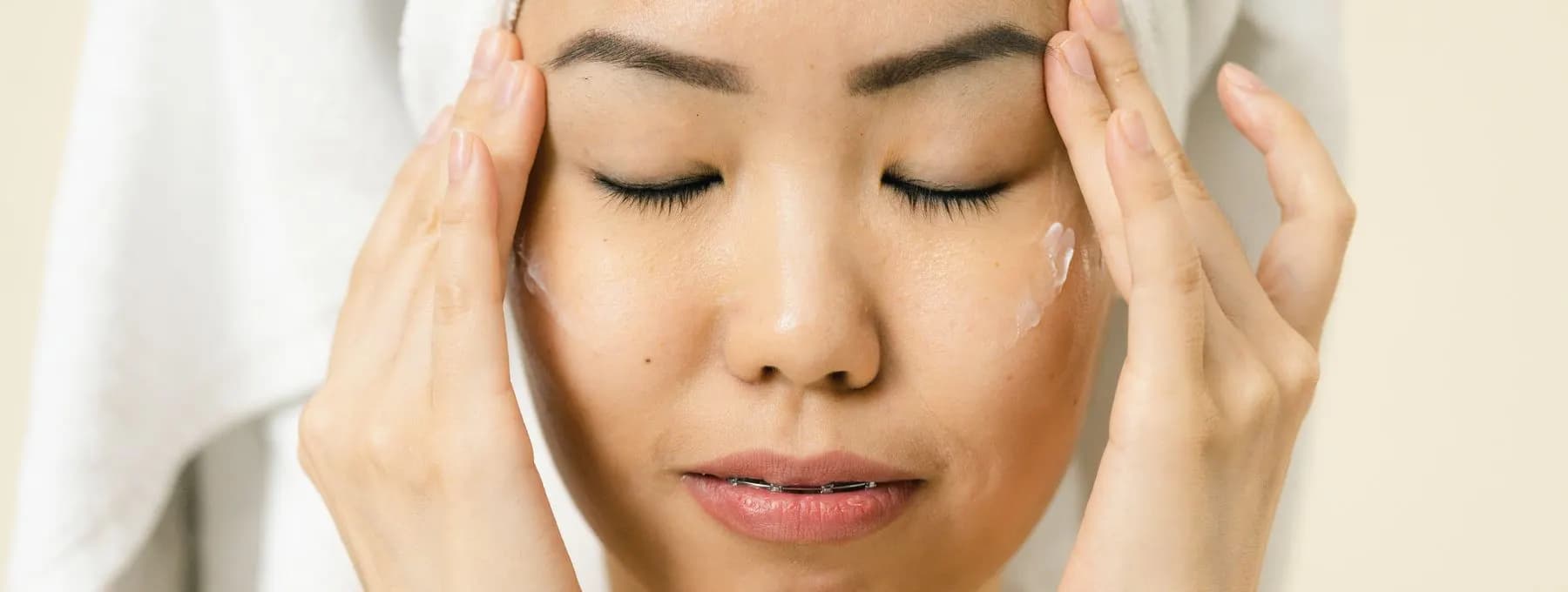 hands resting against a freshly washed face
