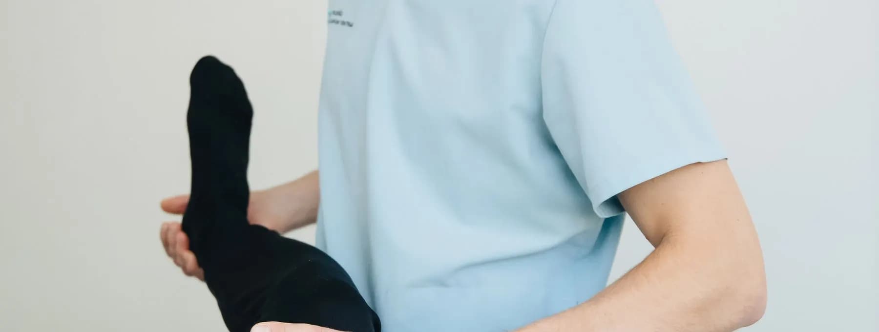 a physiotherapist stretching a patient's leg