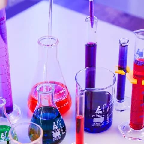 flasks of coloured liquid under light
