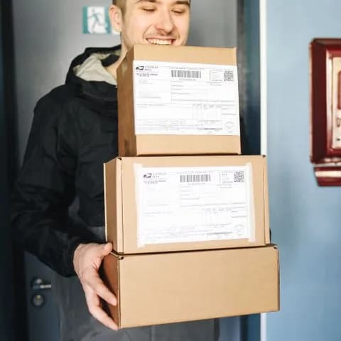 a courier carrying labelled parcels