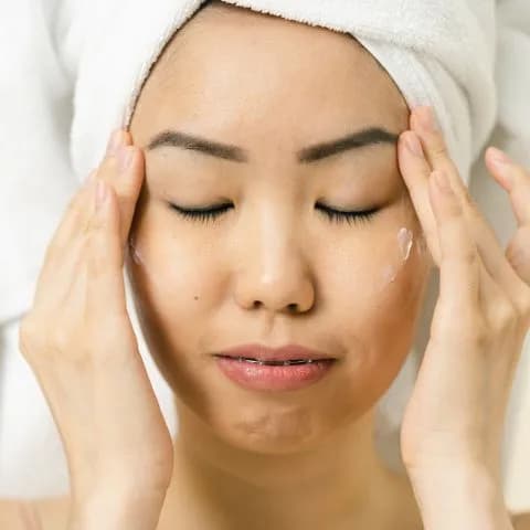 hands resting against a freshly washed face