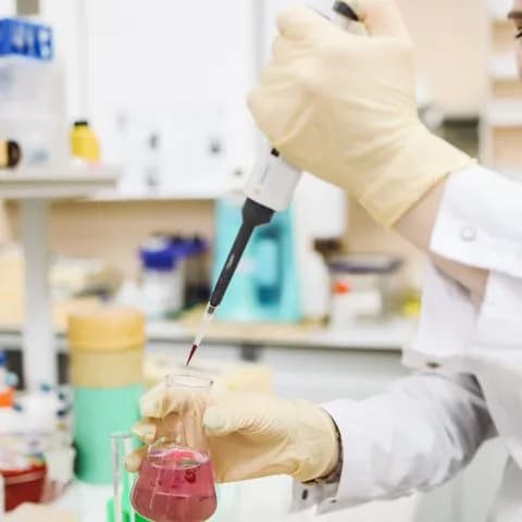 a pipette transferring a sample into a beaker