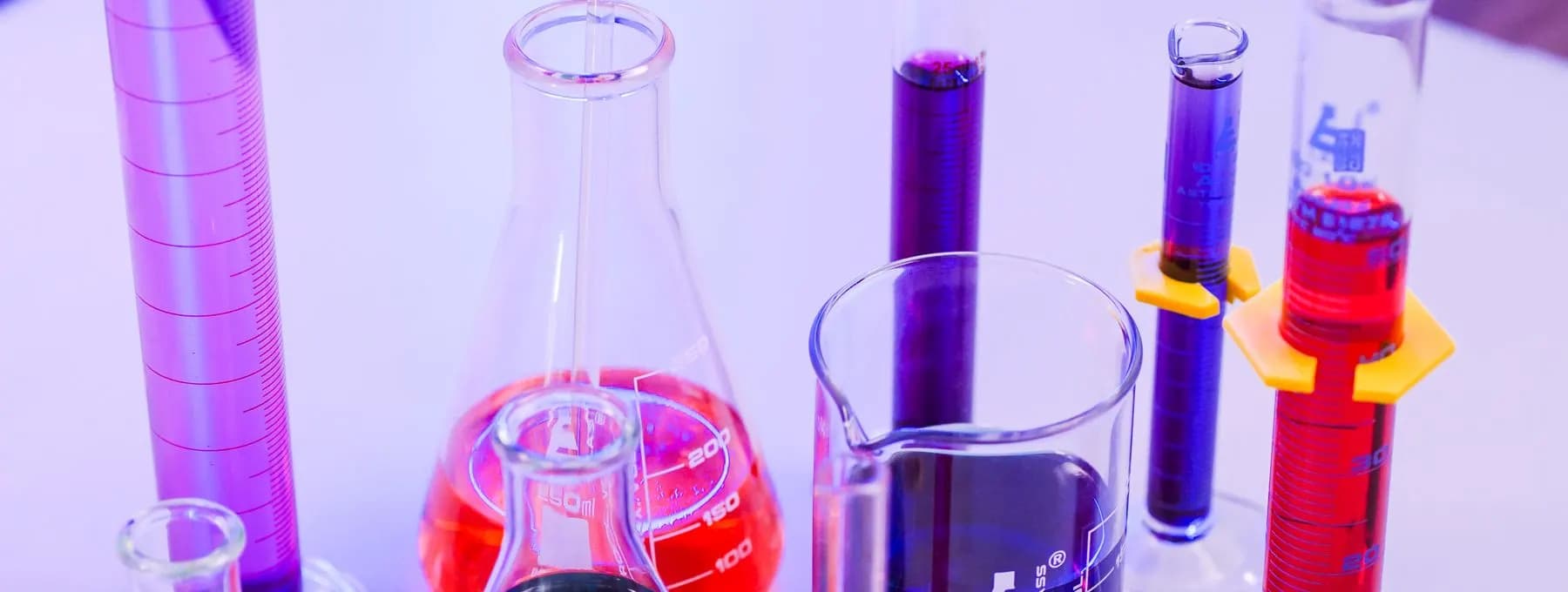 flasks of coloured liquid under light