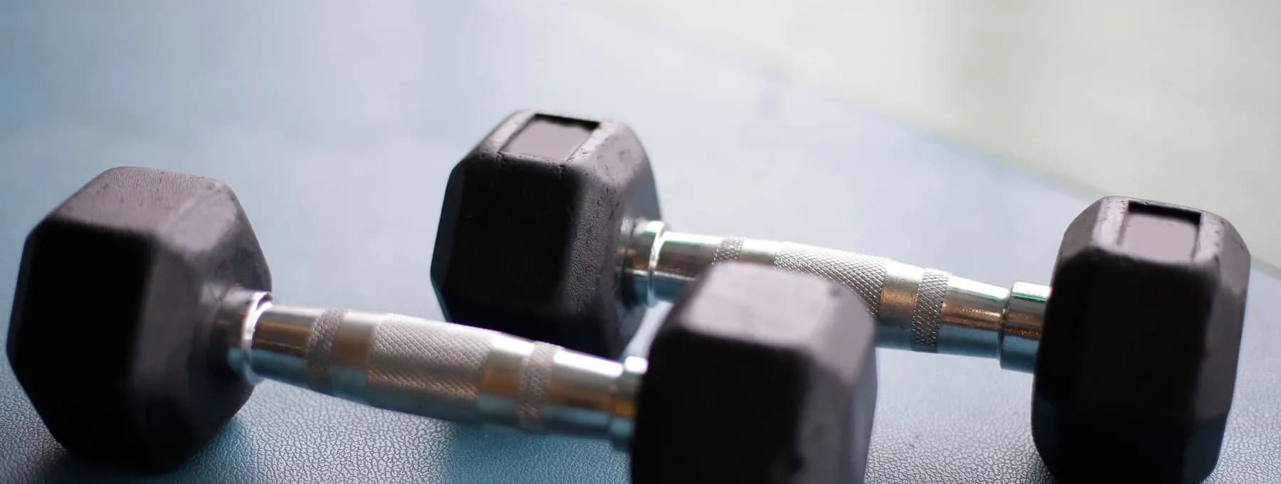 a dumbbell resting on a gym floor