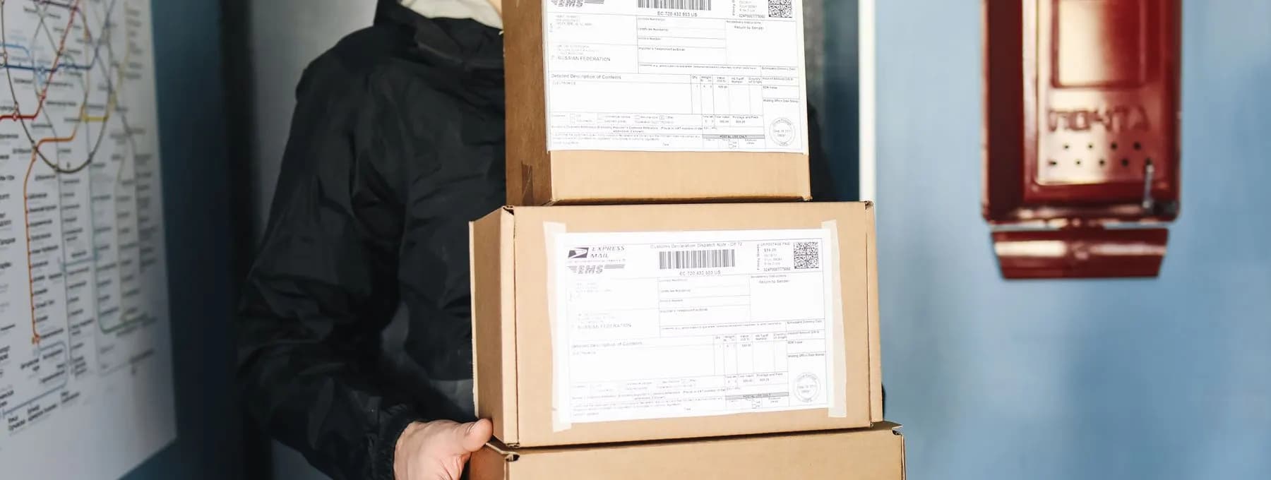 a courier carrying labelled parcels