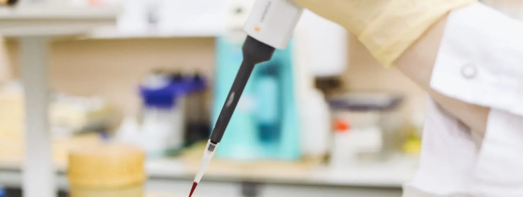 a pipette transferring a sample into a beaker